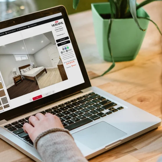 Searching on laptop for flooring design inspiration